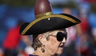 A Tampa Bay Buccaneers fans arrives before the NFL Super Bowl 55 football game between the Kansas City Chiefs and Tampa Bay Buccaneers, Sunday, Feb. 7, 2021, in Tampa, Fla. (AP Photo/Mark Humphrey)