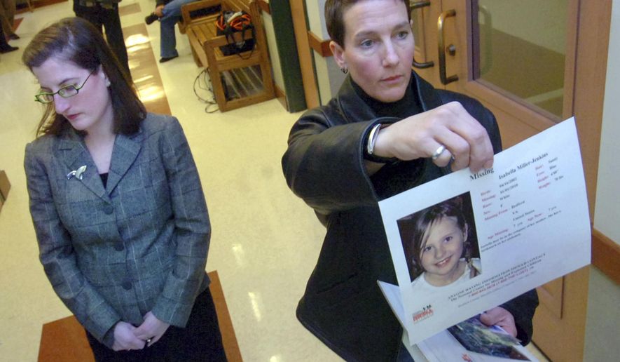 Janet Jenkins, right, of Fair Haven, Vt. who is involved in a same-sex custody battle with Virginia mother Lisa Miller, holds up a photo of her daughter, Isabella, for television cameras after a family court judge in Rutland, Vt., issued an arrest warrant for Lisa Miller on Tuesday, Feb. 23, 2010. A woman who allegedly fled the United States for Nicaragua in 2009 rather than share custody of her child with her former same-sex partner has been arrested in Miami. Federal court records say that Lisa Miller was taken into federal custody Jan. 27. She is awaiting transfer to Buffalo, New York, where she was indicted in 2014 on international parental kidnapping charges.  (Vyto Starinskas/Rutland Herald via AP, file)