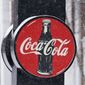A Coca-Cola sign hangs outside a Coca-Cola distributor, Tuesday, Feb. 9, 2021, in Bedford, Ohio. The resurgent coronavirus slowed Coca-Cola’s recovery in the fourth quarter, and the company said the slump has continued through the first months of this year. (AP Photo/Tony Dejak)