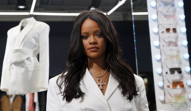 FILE - Rihanna poses as she unveils her first fashion designs for Fenty at a pop-up store in Paris, France, on May 22, 2019. LVMH Moët Hennessy Louis Vuitton, the world’s largest luxury group, has put Rihanna’s Fenty fashion collection on hold. The move, confirmed by LVMH Wednesday, comes nearly two years after the fashion conglomerate announced the collaboration with the pop artist and business mogul.  (AP Photo/Francois Mori, File)