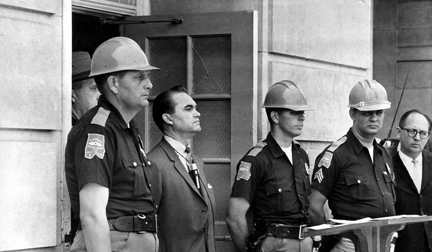 In this June 11, 1963, file photo, Gov. George Wallace blocks the entrance to the University of Alabama as he turned back a federal officer attempting to enroll two black students at the university campus in Tuscaloosa, Ala.  (AP Photo/File)  ** FILE **