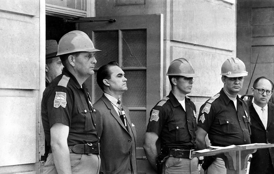 In this June 11, 1963, file photo, Gov. George Wallace blocks the entrance to the University of Alabama as he turned back a federal officer attempting to enroll two black students at the university campus in Tuscaloosa, Ala.  (AP Photo/File)  ** FILE **