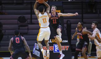 Tennessee guard Jaden Springer, left, shoots against Georgia&#x27;s Jaxon Etter, right, during an NCAA college basketball game Wednesday, Feb. 10, 2021, in Knoxville, Tenn., in Knoxville, Tenn. (Randy Sartin/Pool Photo via AP)