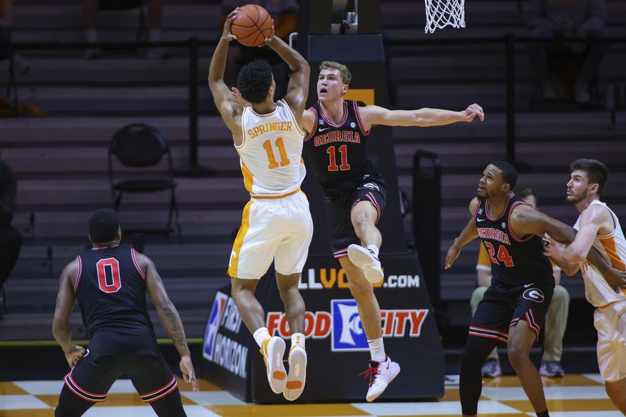 Tennessee guard Jaden Springer, left, shoots against Georgia&#x27;s Jaxon Etter, right, during an NCAA college basketball game Wednesday, Feb. 10, 2021, in Knoxville, Tenn., in Knoxville, Tenn. (Randy Sartin/Pool Photo via AP)