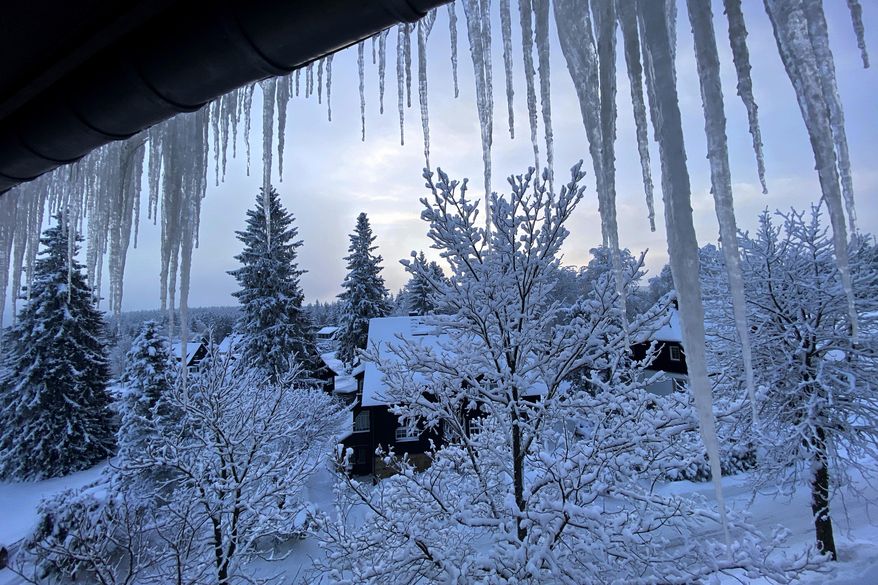 Icicles form on a window outside a house early morning in Altenberg, Germany, Wednesday, Feb. 10, 2021. (AP Photo/Matthias Schrader)