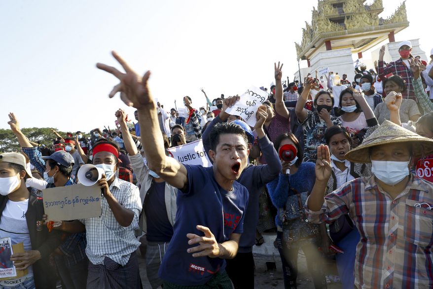 FILE - In this Feb. 10, 2021, file photo, demonstrators flash a three-fingered symbol of resistance against the military coup and shout slogans calling for the release of detained Myanmar leader Aung San Suu Kyi during a protest in Mandalay, Myanmar. When army generals in Myanmar staged a coup last week, they briefly cut internet access in an apparent attempt to stymie protests. Around the world, shutting down the internet has become an increasingly popular tactic by repressive and authoritarian regimes and some illiberal democracies. (AP Photo, File)