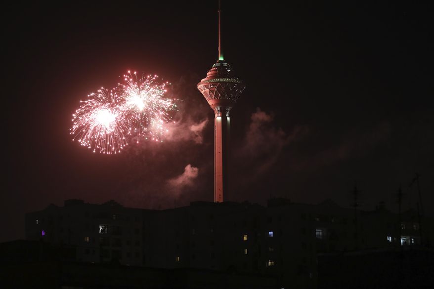 Fireworks explode next to Milad telecommunications tower during celebrations marking the 42nd anniversary of Iran's Islamic Revolution, in Tehran, Iran, Tuesday, Feb. 9, 2021. The Islamic Revolution in February of 1979 toppled the late pro-U.S. Shah Mohammad Reza Pahlavi and brought Islamic clerics to power. (AP Photo/Vahid Salemi)