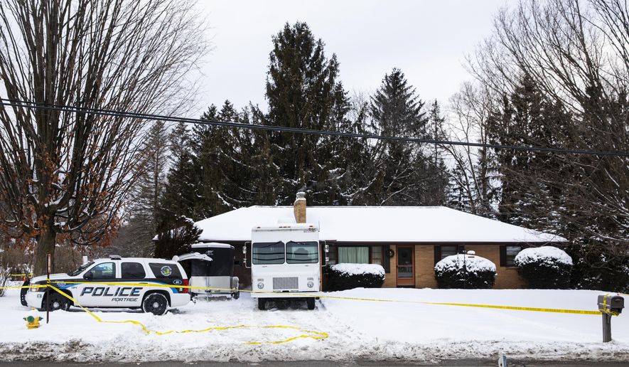 Portage police investigate a missing persons case in Portage, Mich. on Tuesday, Feb. 9, 2021. Police checking on a Kalamazoo-area man who didn’t report to work online put yellow tape around the property. Officers also brought shovels to the backyard. Gary and Laura Johnson, both in their mid-60s, were not at their Portage home, but officers found “signs of violence.” Public Safety Director Nick Armold says there's no “rational explanation” for their disappearance. (Joel Bissell/MLive.com/Kalamazoo Gazette via AP)
