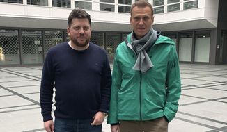 FILE - This file photo provided by Leonid Volkov’s Twitter account on Sunday, Jan. 17, 2021, shows him with Russian opposition leader Alexei Navalny, right, in Germany. Navalny flew back to Russia on Jan. 17 after recovering in Germany from a poisoning with a nerve agent that he blames on Russian authorities. A Moscow court on Wednesday, Feb. 10, ordered the arrest of Volkov, a Navalny ally who lives in Lithuania, but the government in Vilnius has rejected the demand. (Leonid Volkov via AP, File)