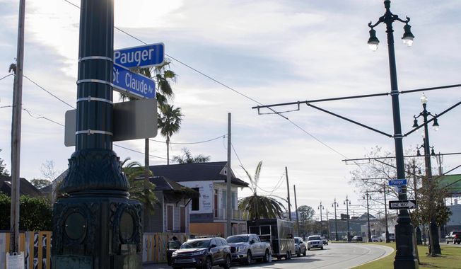 A street sign hangs on St. Claude Avenue, Jan. 30, 2021, in New Orleans. The toll of this year’s toned-down Mardi Gras is evident on St. Claude Avenue, an off-the-beaten-track stretch that has become a destination in recent years. (AP Photo/Dorthy Ray)