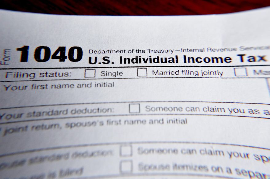 This Wednesday, Feb. 13, 2019, file photo shows part of a 1040 federal tax form printed from the Internal Revenue Service website, in Zelienople, Pa.  (AP Photo/Keith Srakocic, File)