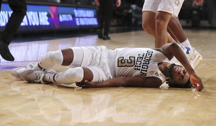 Georgia Tech guard Bubba Parham lies on the court briefly after falling during the team's 57-49 loss to Virginia in an NCAA college basketball game Wednesday, Feb. 10, 2021, in Atlanta. (Curtis Compton/Atlanta Journal-Constitution via AP)