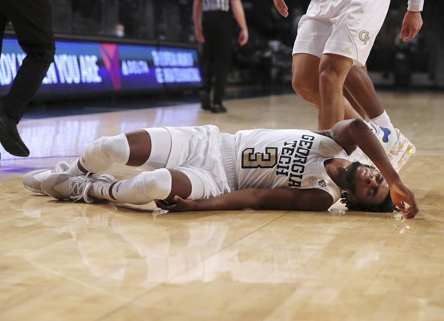 Georgia Tech guard Bubba Parham lies on the court briefly after falling during the team's 57-49 loss to Virginia in an NCAA college basketball game Wednesday, Feb. 10, 2021, in Atlanta. (Curtis Compton/Atlanta Journal-Constitution via AP)