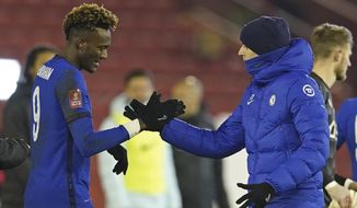 Chelsea&#x27;s head coach Thomas Tuchel, right shakes hands with match winner Chelsea&#x27;s Tammy Abraham at the end of the English FA Cup fifth round soccer match between Barnsley and Chelsea at the Oakwell Stadium in Barnsley, England,Thursday Feb. 11, 2021. (AP Photo/Dave Thompson, Pool)