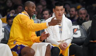 FILE - In this Wednesday, Nov. 26, 2014 file photo, Los Angeles Lakers guard Kobe Bryant, left, talks with guard Jeremy Lin during the first half of an NBA basketball game against the Memphis Grizzlies in Los Angeles. For the G League Ignite, it was a beginning. For Jeremy Lin, it may be a new beginning. He’s one of the former NBA players in the G League bubble at Walt Disney World in Lake Buena Vista, Florida this month, as part of the Santa Cruz Warriors. (AP Photo/Mark J. Terrill, File)