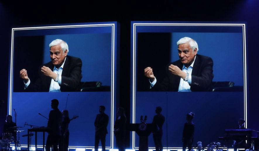 In this May 29, 2020 file photo, images of Ravi Zacharias are displayed in the Passion City Church during a memorial service for him in Atlanta. A law firm&#39;s investigators have released a scathing report on their four-month investigation of alleged sexual misconduct by Zacharias, who founded a global Christian ministry that bears his name. (AP Photo/Brynn Anderson, File)