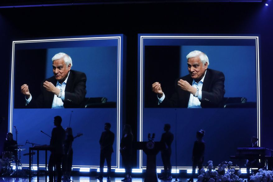 In this May 29, 2020 file photo, images of Ravi Zacharias are displayed in the Passion City Church during a memorial service for him in Atlanta. A law firm&#39;s investigators have released a scathing report on their four-month investigation of alleged sexual misconduct by Zacharias, who founded a global Christian ministry that bears his name. (AP Photo/Brynn Anderson, File)