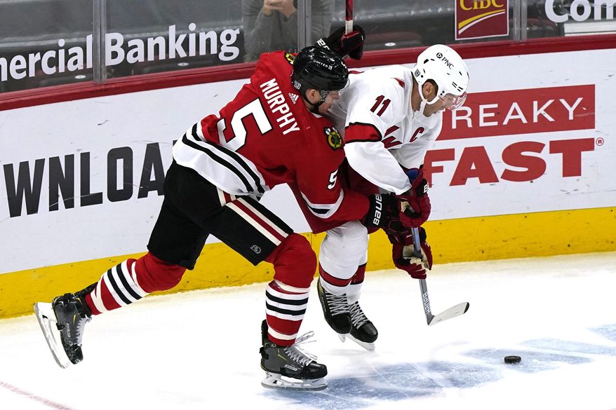 Carolina Hurricanes' Jordan Staal, right, works for the puck against Chicago Blackhawks' Connor Murphy during the second period of an NHL hockey game in Chicago, Thursday, Feb. 4, 2021. (AP Photo/Nam Y. Huh)