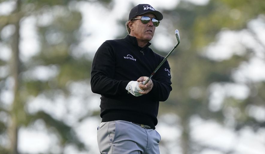 Phil Mickelson follows his approach shot to the 10th green of the Spyglass Hill Golf Course during the first round of the AT&amp;amp;T Pebble Beach Pro-Am golf tournament, Thursday, Feb. 11, 2021, in Pebble Beach, Calif. (AP Photo/Eric Risberg)
