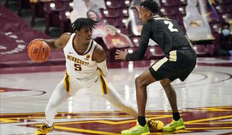 Minnesota&#39;s Marcus Carr (5) drives as Purdue&#39;s Eric Hunter Jr. (2) defends in the first half of an NCAA college basketball game, Thursday, Feb. 11, 2021, in Minneapolis. (AP Photo/Jim Mone)