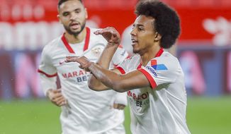 Sevilla&#39;s Jules Kounde celebrates after scoring his side&#39;s first goal during a Spanish Copa del Rey semifinal soccer match between Sevilla and FC Barcelona at Ramon Sanchez Pizjuan stadium in Seville , Spain, Wednesday, Feb. 10, 2021. (AP Photo/Angel Fernandez)