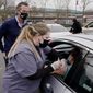 Gov. Gavin Newsom watches as LVN Cari Elkins gives a COVID-19 vaccination at a drive-thru vaccination center at Natomas High School in Sacramento, Calif., Thursday, Feb. 11, 2021. Appointments were needed for the 1,000 vaccinations to be administered for those 65 and over, first responders, health workers, teachers, food and agricultural employers. Called an equitable distribution site, it prioritized those disproportionally impacted by COVID-19, was collaboration between the Natomas&#39; Unified School District, Sacramento County Public Health Department and Sacramento Vice Mayor Angelique Ashby who represents the area. (AP Photo/Rich Pedroncelli)