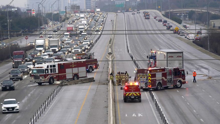 The highway sits closed as emergency crews finish cleaning following accidents caused by ice and low temperatures in Richardson, Texas, Thursday, Feb. 11, 2021. A winter storm brought a coating of ice to parts of Texas. (AP Photo/LM Otero)