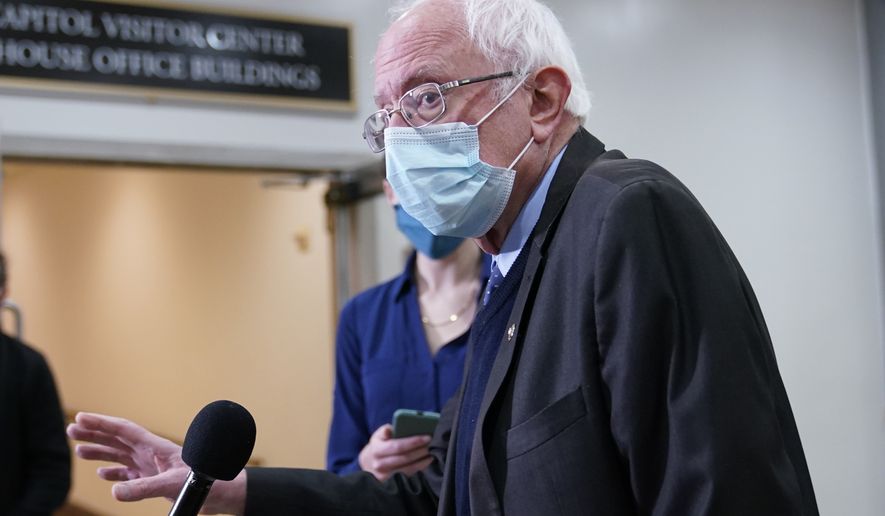 Sen. Bernie Sanders, I-Vt., talks with reporters on Capitol Hill in Washington, Friday, Feb. 12, 2021, on the fourth day of the second impeachment trial of former President Donald Trump. (AP Photo/Susan Walsh)