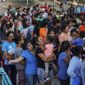 Migrants, many of whom were returned to Mexico under the Trump administration&#x27;s &quot;Remain in Mexico&quot; policy, wait in line to get a meal in an encampment near the Gateway International Bridge in Matamoros, Mexico, Aug. 30, 2019. The Biden administration on Friday, Feb. 12, 2021, announced plans for tens of thousands of asylum-seekers waiting in Mexico for their next immigration court hearings to be released in the United States while their cases proceed. (AP Photo/Veronica G. Cardenas, File)  **FILE**