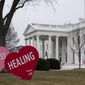 A Valentine&#39;s Day decoration, signed by first lady Jill Biden, sits on the North Lawn of the White House, Friday, Feb. 12, 2021, in Washington. (AP Photo/Evan Vucci)