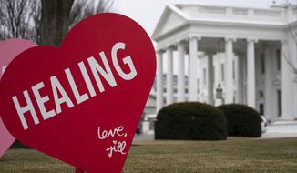 A Valentine&#39;s Day decoration, signed by first lady Jill Biden, sits on the North Lawn of the White House, Friday, Feb. 12, 2021, in Washington. (AP Photo/Evan Vucci)