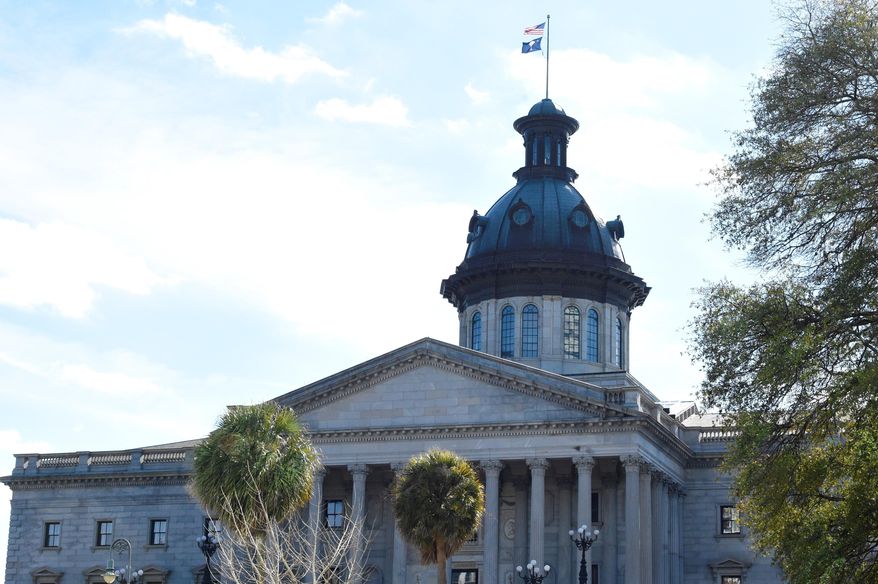 Demonstrations at the South Carolina Statehouse remained peaceful on Sunday, Jan. 17, 2021, in Columbia, S.C. There was a stepped-up law enforcement presence outside state capitol buildings across the country due to rumors of planned demonstrations ahead of President-elect Joe Biden's inauguration. (AP Photo/Meg Kinnard)