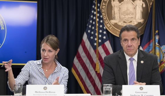 FILE — In this Sept. 14, 2018 file photo, Secretary to the Governor Melissa DeRosa, is joined by New York Gov. Andrew Cuomo as she speaks to reporters during a news conference, in New York. De Rosa, Cuomo&#39;s top aide, told top Democrats frustrated with the administration&#39;s long-delayed release of data about nursing home deaths that the administration &amp;quot;froze&amp;quot; over worries about what information was &amp;quot;going to be used against us,&amp;quot; according to a Democratic lawmaker who attended the Wednesday, Feb. 10, 2021 meeting and a partial transcript provided by the governor&#39;s office. (AP Photo/Mary Altaffer, File)