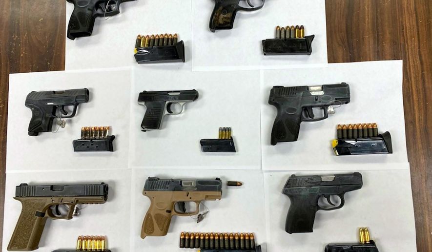 This photo, provided by the New York City Police Department, Friday, Feb. 12, 2021, shows eight guns recovered on a packed party bus, near the waterfront in the Brooklyn borough of New York, early Friday. Police arrested more than a dozen people after they were alerted to social media posts showing some passengers aboard posing with firearms, police said. (New York City Police Department via AP) ** FILE **