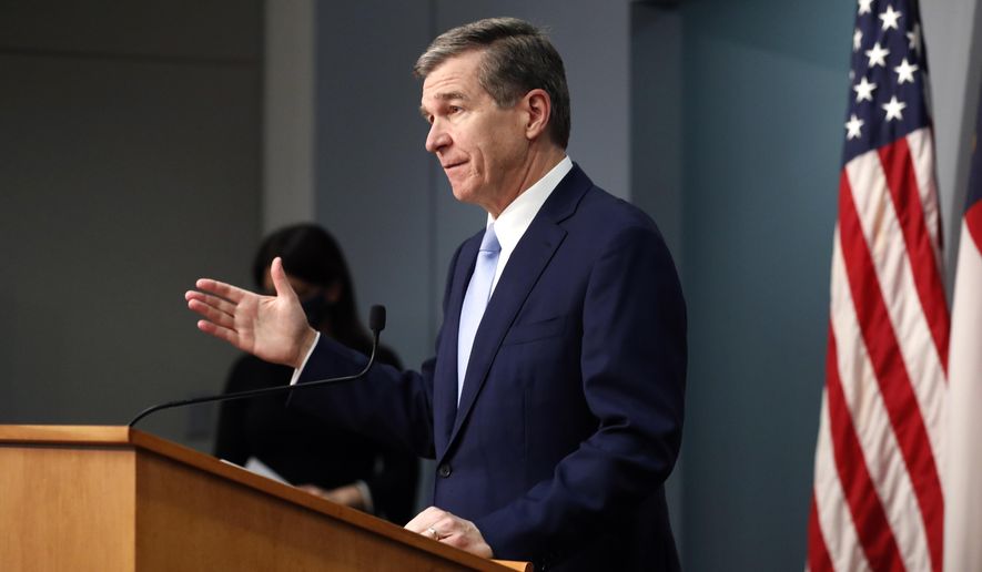 North Carolina Gov. Roy Cooper speaks during a briefing at the Emergency Operations Center in Raleigh, N.C., Wednesday, Feb. 10, 2021. (Ethan Hyman/The News & Observer via AP)