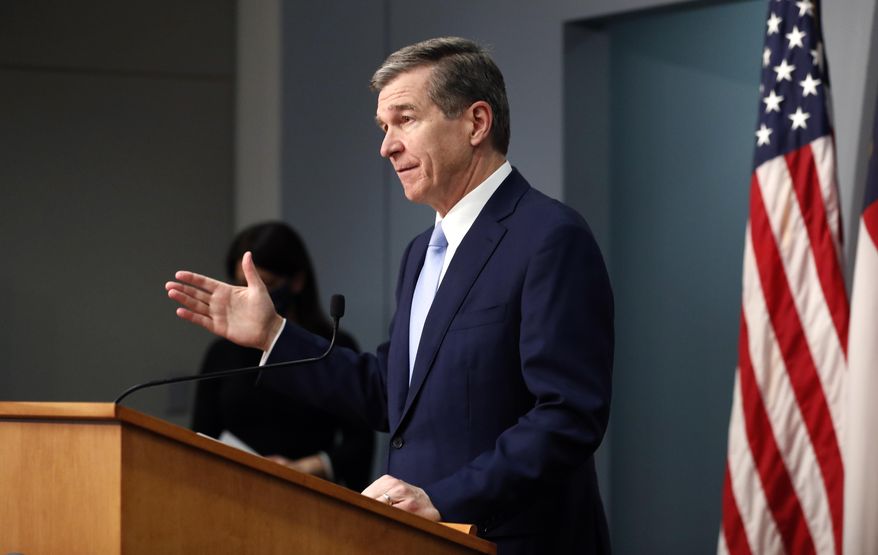 North Carolina Gov. Roy Cooper speaks during a briefing at the Emergency Operations Center in Raleigh, N.C., Wednesday, Feb. 10, 2021. (Ethan Hyman/The News & Observer via AP)