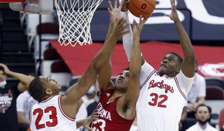 Indiana forward Trayce Jackson-Davis, center, reaches for a rebound between Ohio State forward Zed Key, left, and forward E.J. Liddell during the first half of an NCAA college basketball game in Columbus, Ohio, Saturday, Feb. 13, 2021. (AP Photo/Paul Vernon)