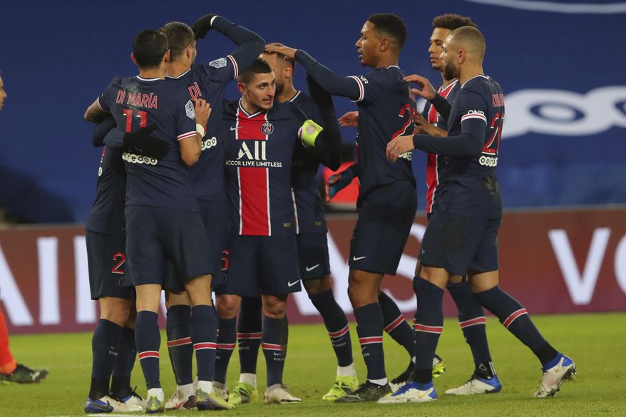 PSG players celebrate their third goal during the French League One soccer match between Paris Saint-Germain and Montpellier at the Parc des Princes stadium in Paris, France, Friday, Jan.22, 2021. (AP Photo/Thibault Camus)