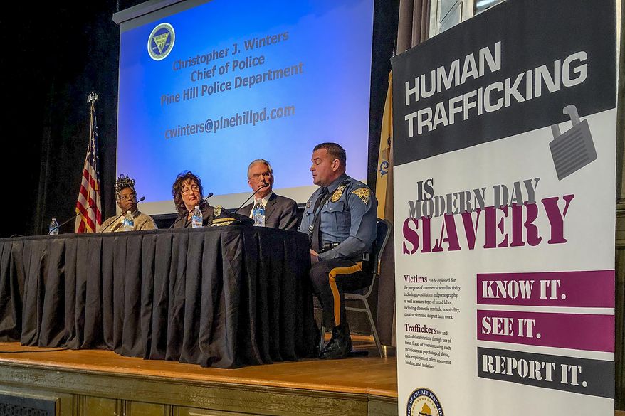 FILE — In this Jan. 24, 2020 file photo, panelists at the New Jersey attorney general's annual human trafficking awareness event talk about how to prevent the crime, in Trenton, N.J. After failing for five years to fully carry out a state anti-human trafficking law, New Jersey officials made good on a promise last year to reinvigorate the commission tasked with preventing the crime. (AP Photo/Mike Catalini, File)