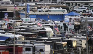 Motor homes are shown in the infield at the Daytona International Speedway before a truck race Friday, Feb. 12, 2021, in Daytona Beach, Fla. Daytona is used to shirtless fans partying in the infield. But what about maskless ones? Usually the biggest NASCAR party of the season, the sport will have to figure out how to police up to 30,000 fans who may have little interest in sticking to the pandemic guidelines. How many fans will actually come remains to be seen? (AP Photo/Chris O&#39;Meara)