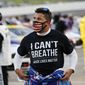 FILE - In this June 10, 2020, file photo, driver Bubba Wallace, wearing an &amp;quot;I Can&#39;t Breathe&amp;quot; T-shirt waits for the start of a NASCAR Cup Series auto race in Martinsville, Va. A predominantly white sport with deep Southern roots and a longtime embrace of Confederate symbols, NASCAR was forced last summer to face its own checkered racial history during the country’s social unrest. (AP Photo/Steve Helber, File)