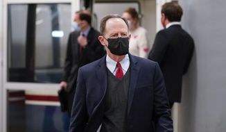 In this file photo, Sen. Pat Toomey, R-Pa., walks on Capitol Hill in Washington, Saturday, Feb. 13, 2021, on the fifth day of the second impeachment trial of former President Donald Trump. (AP Photo/Alex Brandon)