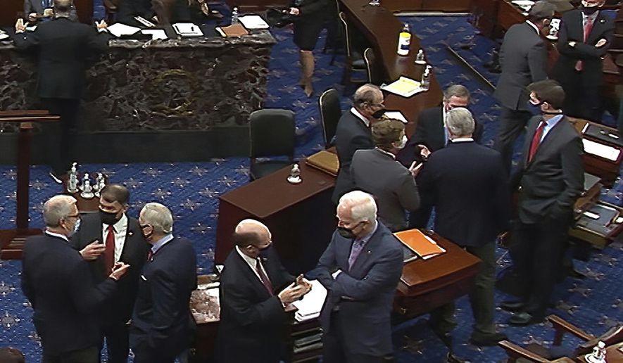 In this image from video, Republican senators and staff talk on the floor after a vote on the motion to allow witnesses in the second impeachment trial of former President Donald Trump in the Senate at the U.S. Capitol in Washington, Saturday, Feb. 13, 2021. (Senate Television via AP)