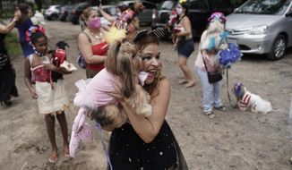 Francisca poses with her pet dog Eva during the annual dog Carnival parade in Rio de Janeiro, Brazil, Saturday, Feb. 13, 2021. Rio&#39;s Carnival festivities were canceled due to the new coronavirus pandemic, but pet lovers from around the city gathered for the Carnival tradition that drew participants with their furry, four-legged companions to compete for best costume. (AP Photo/Silvia Izquierdo)