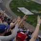 Fans hold up three fingers during a lap three tribute honoring the late Dale Earnhardt, Sr., during the NASCAR Daytona 500 auto race at Daytona International Speedway, Sunday, Feb. 14, 2021, in Daytona Beach, Fla. Dale Earnhardt, Sr., the all-time winner at Daytona, was killed in a fatal car crash at the speedway 20-years ago today. (AP Photo/Chris O&#39;Meara) **FILE**