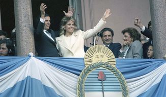 FILE - In this July 8, 1989 file photo, Argentina&#39;s President Carlos Menem, accompanied by his wife Zulema Yoma, waves from the balcony of the Government Palace, after being sworn in as the new President of Argentina, in Buenos Aires, Argentina. Argentine President Alberto Fernández has confirmed on Sunday, Feb. 14, 2021, that Menem, who had been ailing in recent weeks has died. ( AP Photo/Alejandro Querol, File)