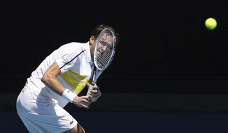 Russia&#39;s Daniil Medvedev hits a backhand to United States&#39; Mackenzie McDonald during their fourth round match at the Australian Open tennis championships in Melbourne, Australia, Monday, Feb. 15, 2021. (AP Photo/Hamish Blair)
