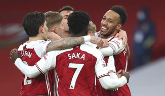 Arsenal players celebrate after Arsenal&#x27;s Pierre-Emerick Aubameyang, right, scored his side&#x27;s opening goal during the English Premier League soccer match between Arsenal and Leeds United at the Emirates stadium in London, England, Sunday, Feb. 14, 2021. (Catherine Ivill/Pool via AP)