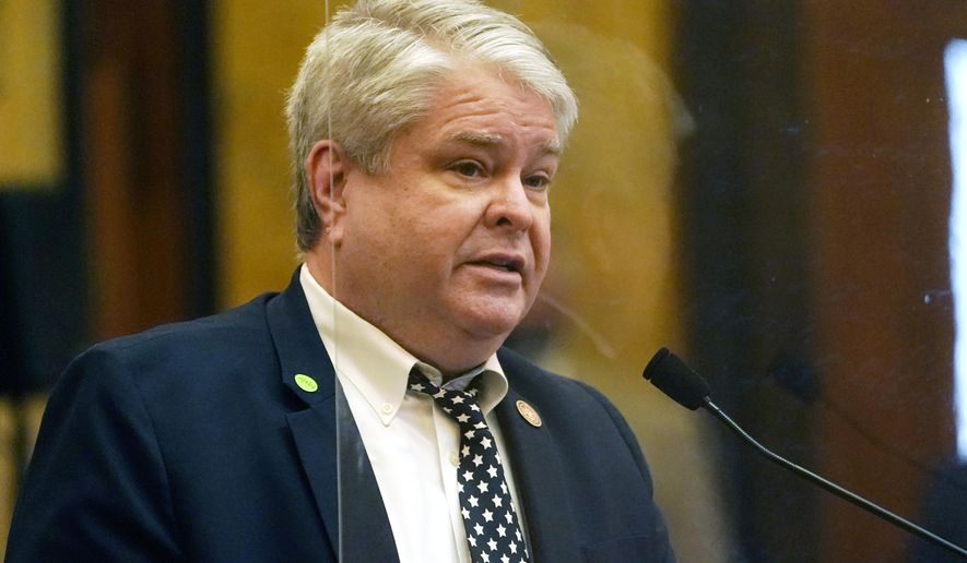 Rep. Steve Hopkins, R-Southaven, stands behind a clear safety barrier that surrounds the speaker's well as he presents a bill for consideration the Capitol in Jackson, Miss., Thursday, Feb. 4, 2021. Legislators continue to debate the long lists of bills that survived the first big deadline of the session. (AP Photo/Rogelio V. Solis)