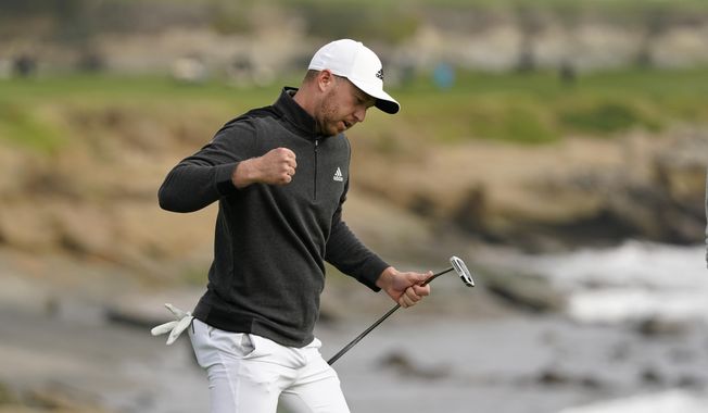 Daniel Berger reacts after making an eagle putt on the 18th green of the Pebble Beach Golf Links during the final round of the AT&amp;amp;T Pebble Beach Pro-Am golf tournament Sunday, Feb. 14, 2021, in Pebble Beach, Calif. Berger won the tournament. (AP Photo/Eric Risberg)